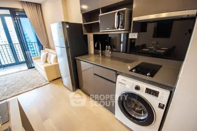 Modern kitchen with sleek appliances and open layout in a stylish apartment.