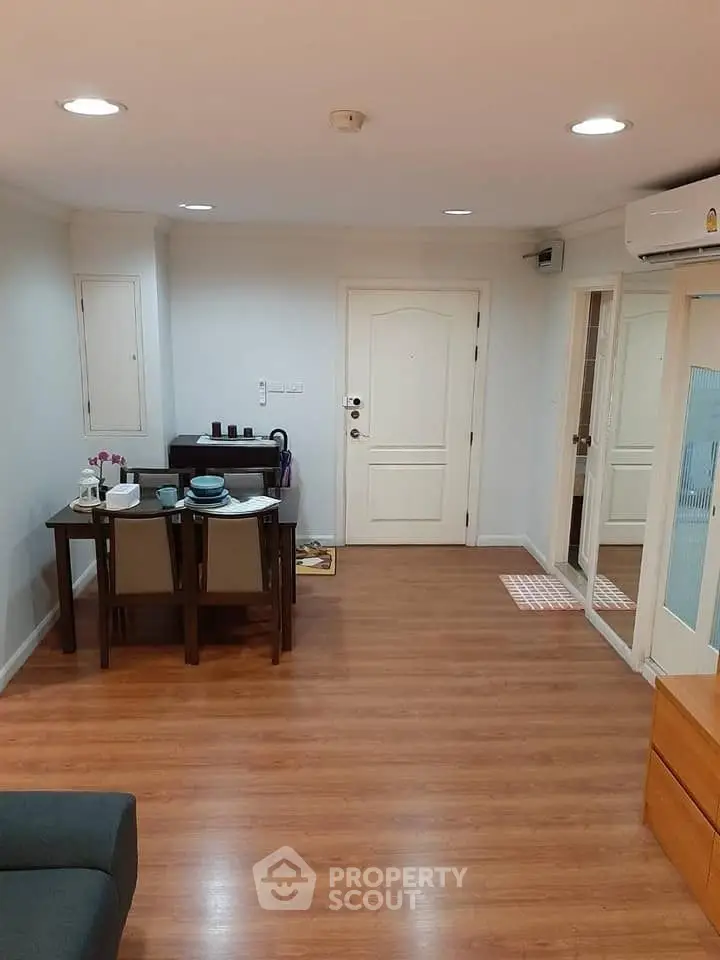 Cozy living room with wooden flooring and modern furniture in a stylish apartment.