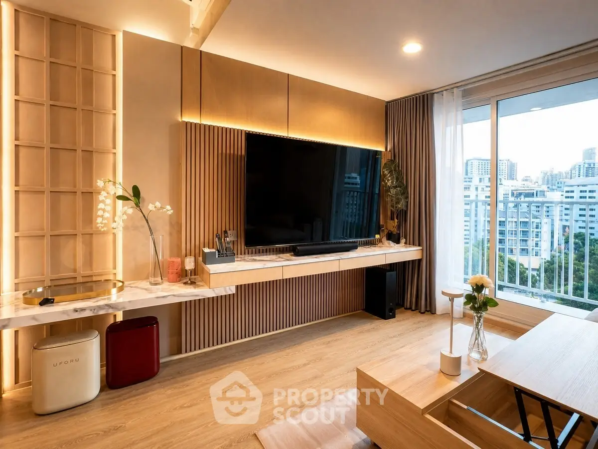 Modern living room with large TV, wooden accents, and city view from balcony.