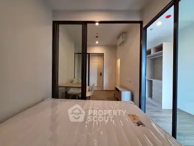 Modern bedroom with sliding glass doors and minimalist furniture