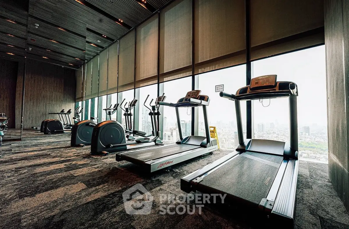Luxurious high-rise gym with panoramic city views and modern fitness equipment.