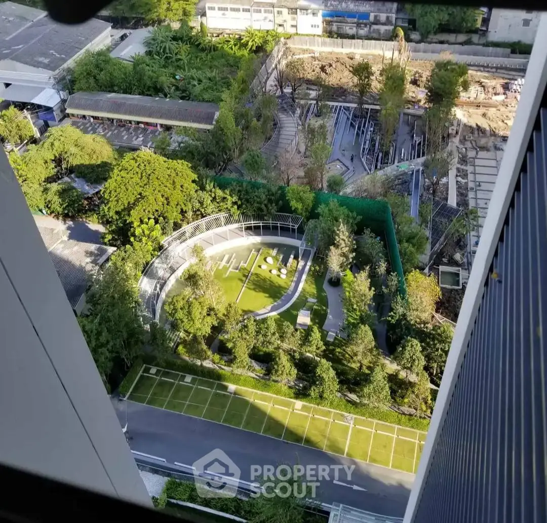 Stunning aerial view of modern garden and surrounding buildings from high-rise perspective.