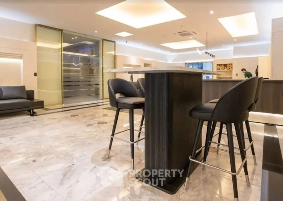 Luxurious modern kitchen with marble flooring and sleek bar seating
