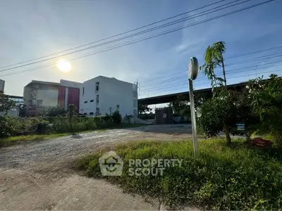 Modern building exterior with lush greenery and clear sky view