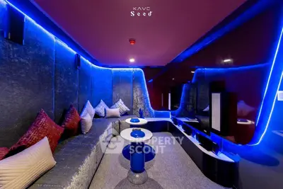 Luxurious modern living room with ambient blue lighting and plush seating