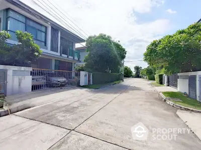 Charming residential street view with modern houses and lush greenery