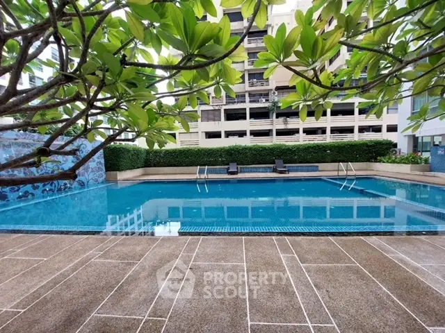 Luxurious residential pool with lush greenery and modern design