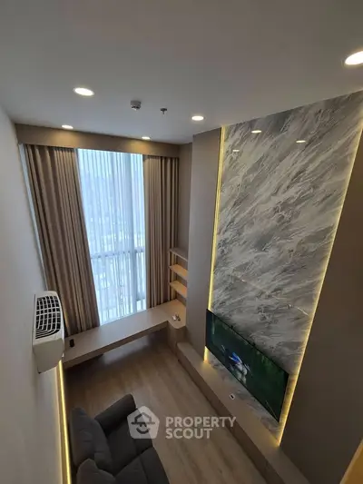 Modern living room with high ceiling, large window, and stylish marble accent wall.