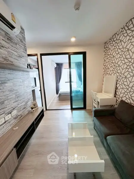 Modern living room with stylish decor and open view to bedroom