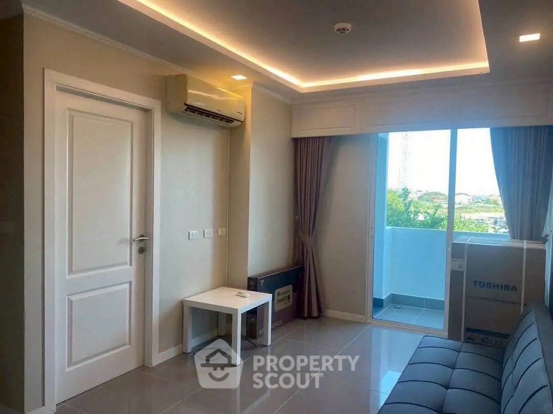 Modern living room with balcony and air conditioning, featuring sleek design and natural light.
