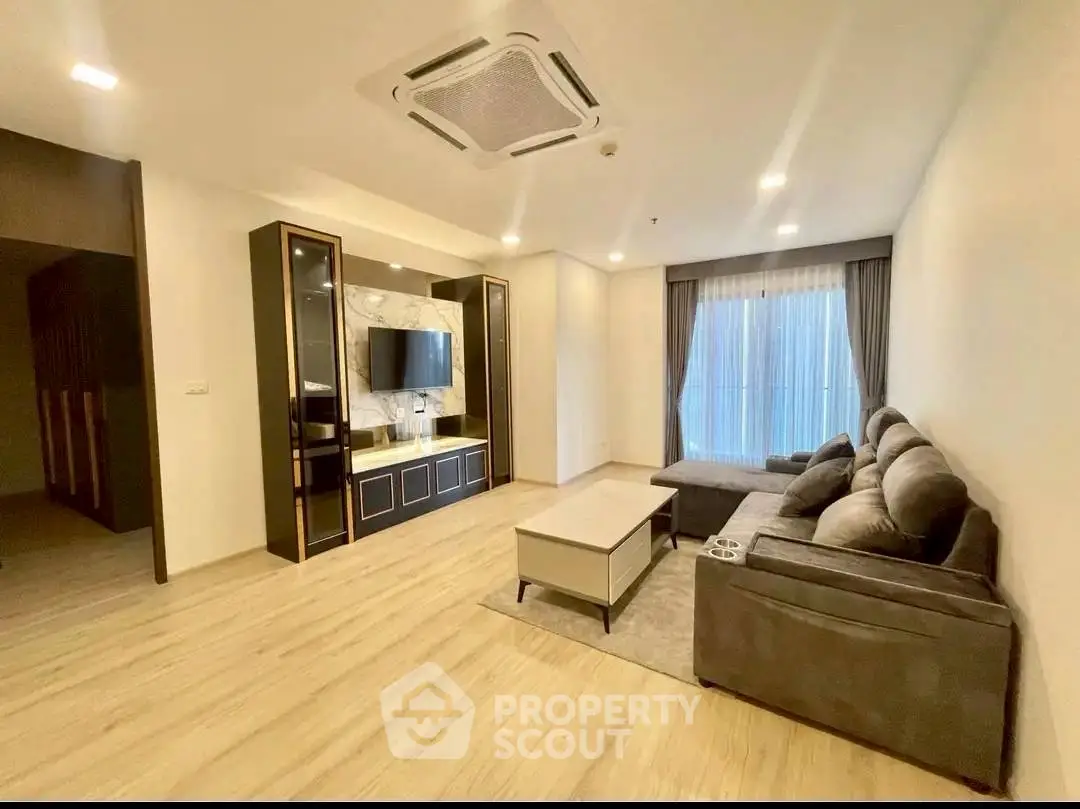 Spacious modern living room with elegant decor and cozy seating area.