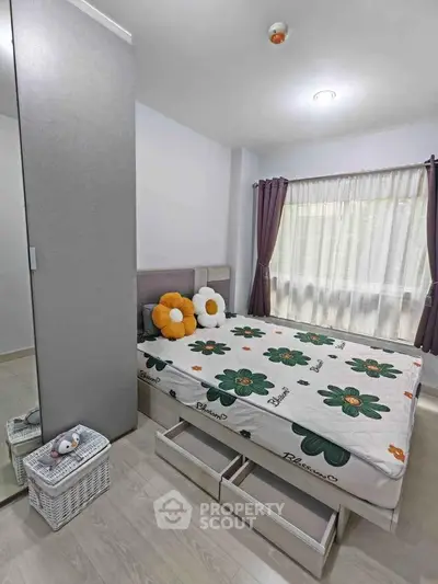 Cozy bedroom with floral bedding and ample storage in modern apartment