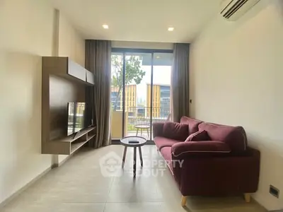 Modern living room with stylish furniture and balcony view in a contemporary apartment.