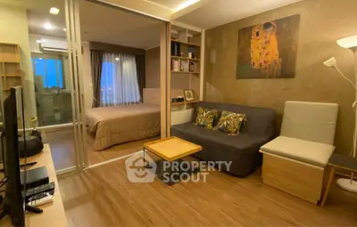 Modern living room with cozy decor and sliding glass doors leading to a stylish bedroom.