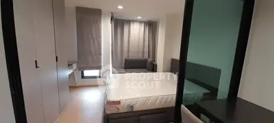 Modern bedroom with large window, cozy bed, and stylish furnishings in a contemporary apartment.