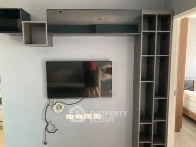 Modern living room with wall-mounted TV and sleek shelving unit