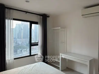 Modern bedroom with city view, featuring minimalist furniture and air conditioning.