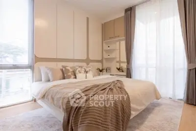 Luxurious modern bedroom with elegant decor and large windows for natural light.