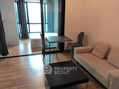 Modern living room with sleek furniture and large windows in a stylish apartment.