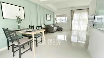 Modern living room with dining area, stylish decor, and natural light.