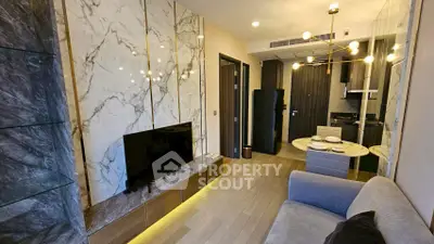 Luxurious modern living room with marble accents and open kitchen layout