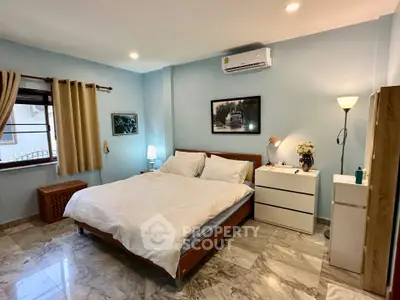 Spacious bedroom with modern decor and natural light