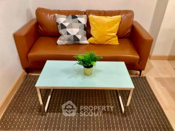 Cozy living room with stylish brown sofa and modern coffee table.