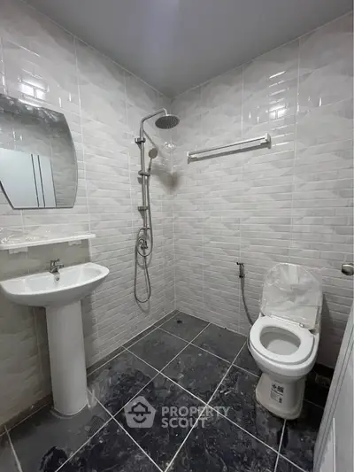 Modern bathroom with sleek tiles and contemporary fixtures.