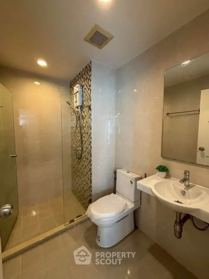 Modern bathroom with glass shower and sleek fixtures