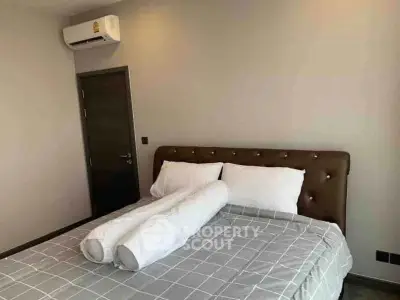 Modern bedroom with stylish bed and air conditioning unit, perfect for comfort and relaxation.