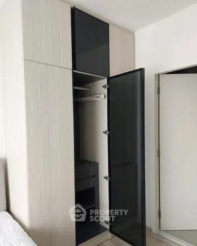 Modern bedroom with sleek wardrobe and mirrored door