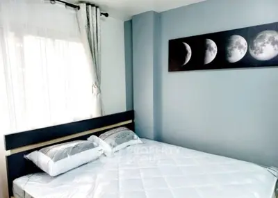 Modern bedroom with stylish moon phase artwork and natural light.