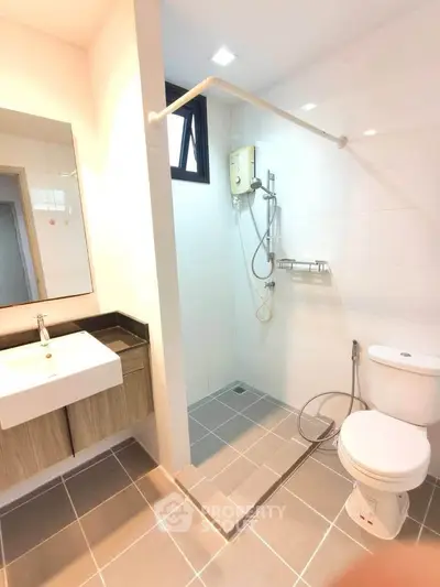 Modern bathroom with sleek fixtures and spacious shower area in a contemporary home.