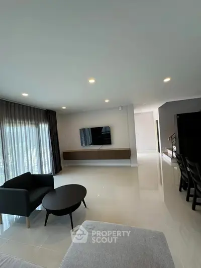Spacious modern living room with sleek furniture and natural light