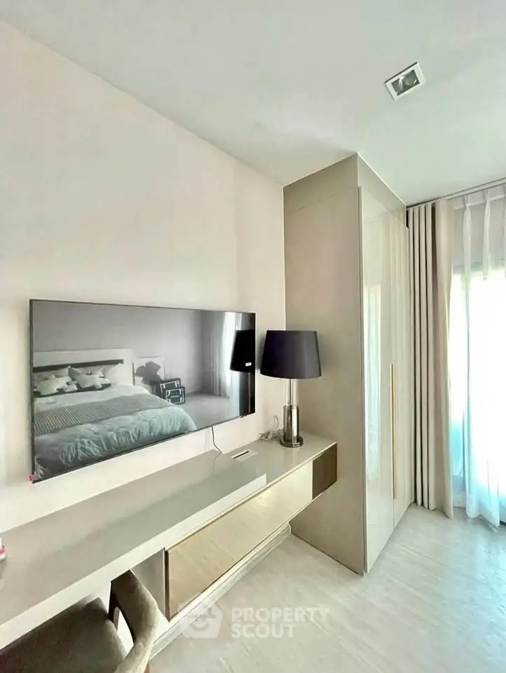 Modern bedroom with sleek TV setup and stylish decor