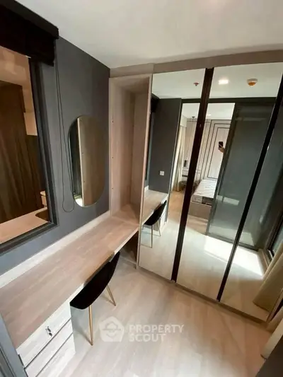 Modern bedroom with sleek mirrored wardrobe and stylish vanity desk