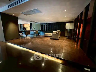 Spacious modern living room with elegant parquet flooring and stylish furniture, perfect for luxury living.