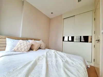 Cozy bedroom with stylish decor and ample natural light, featuring a comfortable bed and modern wardrobe.