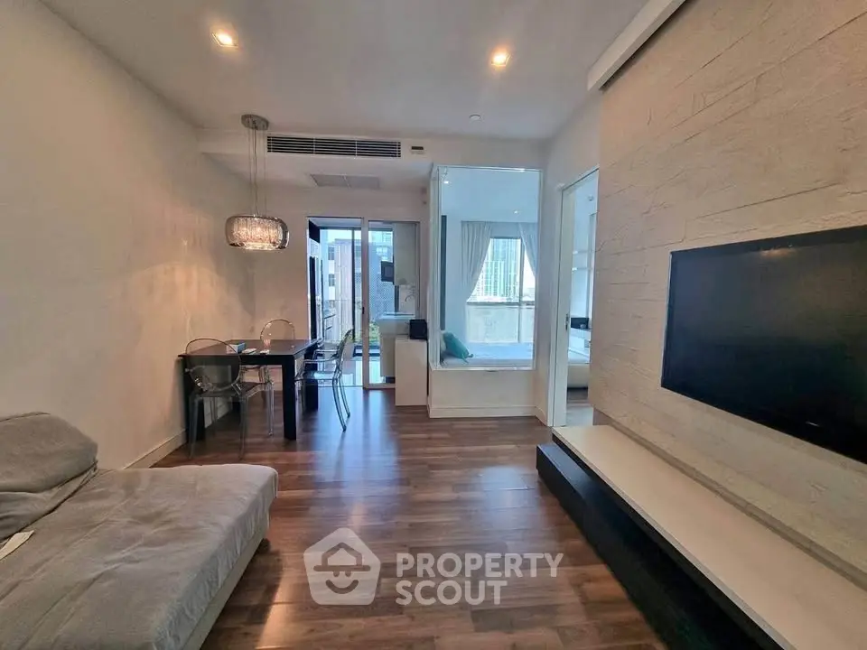 Modern living room with open layout and stylish decor in a high-rise apartment.