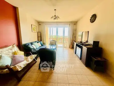 Spacious living room with natural light and balcony access, perfect for relaxation and entertainment.