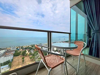 Stunning ocean view from a modern balcony with stylish seating, perfect for relaxation and enjoying the scenery.