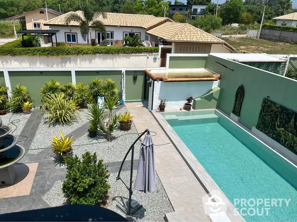 Luxurious villa with private pool and landscaped garden in serene neighborhood.