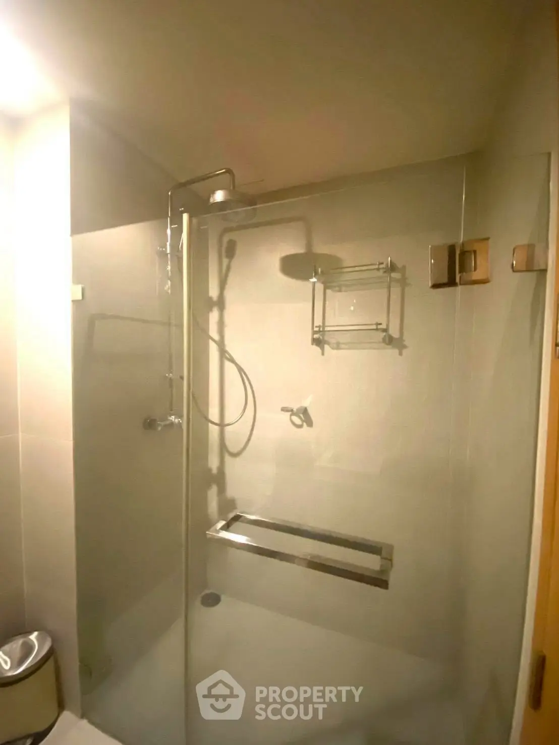 Modern bathroom with glass shower and sleek fixtures in contemporary home.