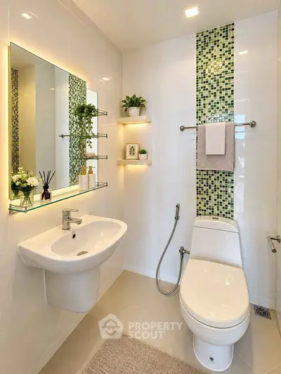 Modern bathroom with stylish green mosaic tiles and elegant fixtures