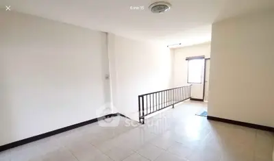 Spacious interior with natural light and tiled flooring, ideal for versatile use.