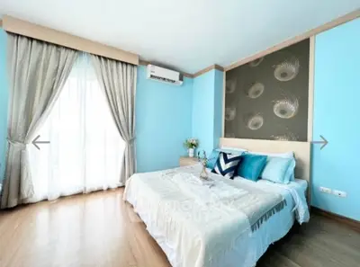 Bright and airy bedroom with elegant decor and large window for natural light.