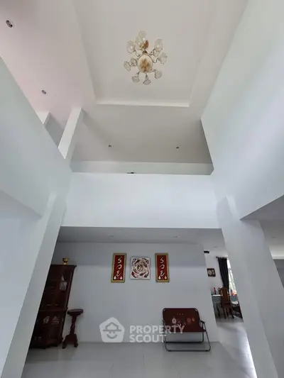 Spacious modern living room with high ceiling and elegant chandelier