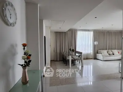 Spacious modern living room with elegant dining area and large windows.