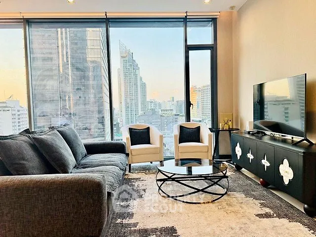 Luxurious modern living room with stunning city view, featuring elegant furniture and floor-to-ceiling windows.