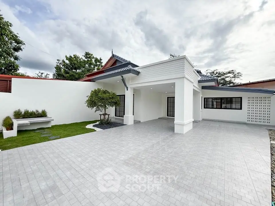 Spacious modern home exterior with large driveway and lush greenery, perfect for family living.